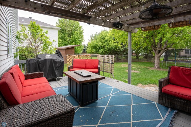 4408 Riverwood Dr N, Fargo, ND 58102 - wooden terrace with a pergola, area for grilling, an outdoor hangout area, a trampoline, and ceiling fan