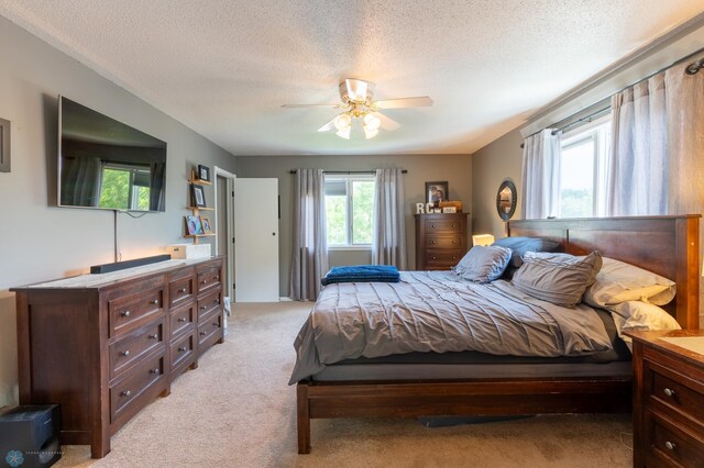 4408 Riverwood Dr N, Fargo, ND 58102 - bedroom with light carpet, a textured ceiling, and ceiling fan