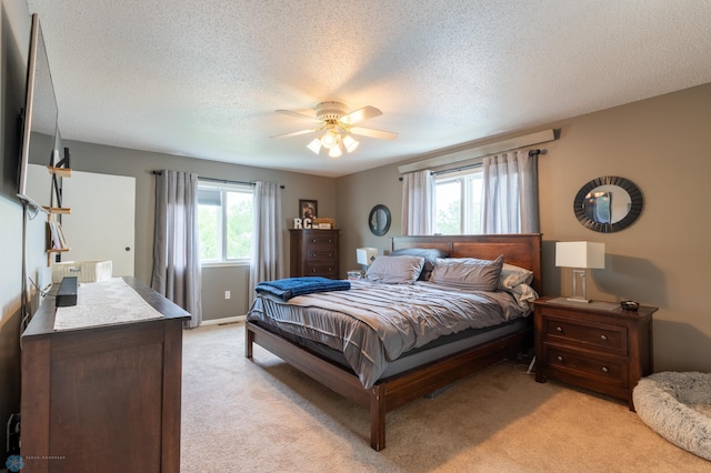 4408 Riverwood Dr N, Fargo, ND 58102 - bedroom featuring light colored carpet, a textured ceiling, and ceiling fan