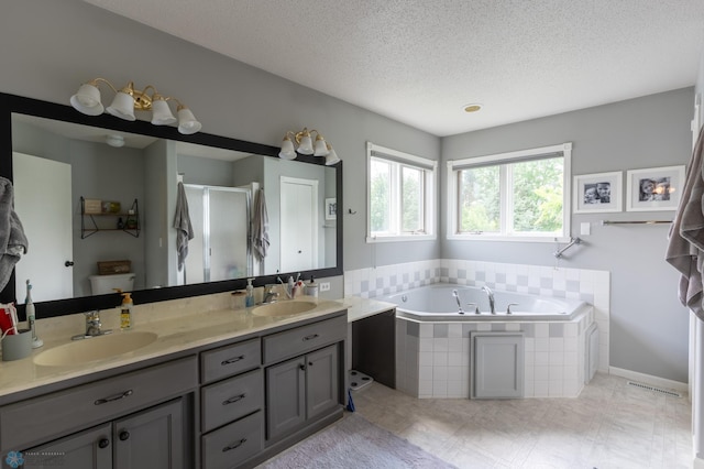 4408 Riverwood Dr N, Fargo, ND 58102 - full bath with double vanity, a bath, a shower stall, and a textured ceiling