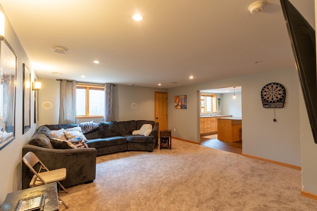 4408 Riverwood Dr N, Fargo, ND 58102 - living area with light colored carpet, recessed lighting, plenty of natural light, and baseboards