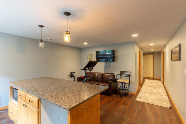 4408 Riverwood Dr N, Fargo, ND 58102 - kitchen with dark wood-style floors, a kitchen island, recessed lighting, open floor plan, and hanging light fixtures