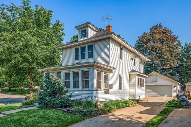 2059 Iglehart Ave, Saint Paul, MN 55104 - view of front of property with an outdoor structure, a chimney, a garage, and cooling unit
