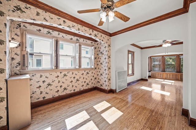 2059 Iglehart Ave, Saint Paul, MN 55104 - unfurnished room featuring a ceiling fan, light wood-type flooring, ornamental molding, baseboards, and arched walkways