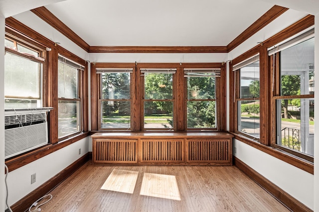 2059 Iglehart Ave, Saint Paul, MN 55104 - unfurnished sunroom featuring radiator heating unit, baseboards, ornamental molding, and wood finished floors