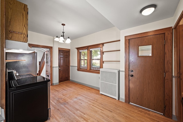 2059 Iglehart Ave, Saint Paul, MN 55104 - entrance foyer with a chandelier, light wood-style floors, and baseboards