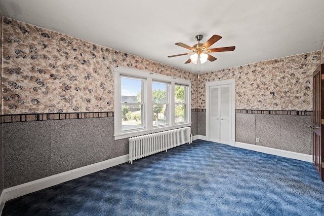 2059 Iglehart Ave, Saint Paul, MN 55104 - empty room featuring radiator heating unit, ceiling fan, dark colored carpet, and wallpapered walls