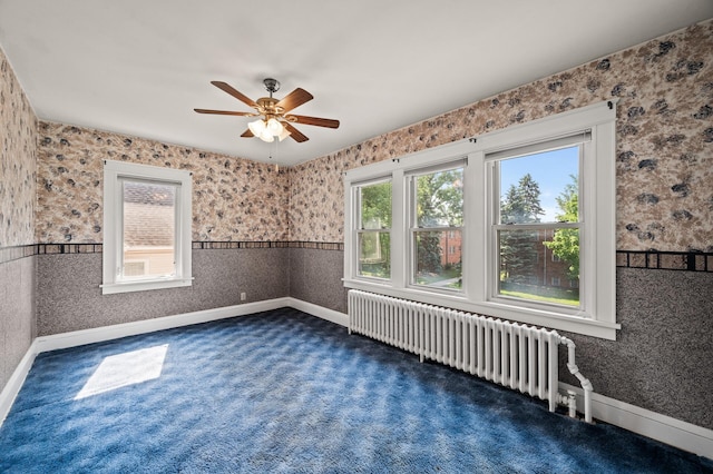 2059 Iglehart Ave, Saint Paul, MN 55104 - empty room with radiator, a ceiling fan, dark carpet, baseboards, and wallpapered walls