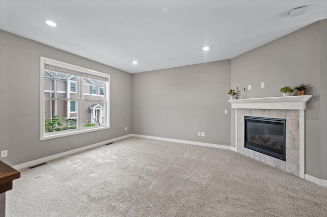5040 93rd Ln N, Brooklyn Park, MN 55443 - unfurnished living room with carpet floors, baseboards, a tiled fireplace, and recessed lighting