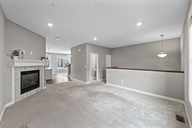 5040 93rd Ln N, Brooklyn Park, MN 55443 - unfurnished living room with carpet flooring, baseboards, a tiled fireplace, and recessed lighting