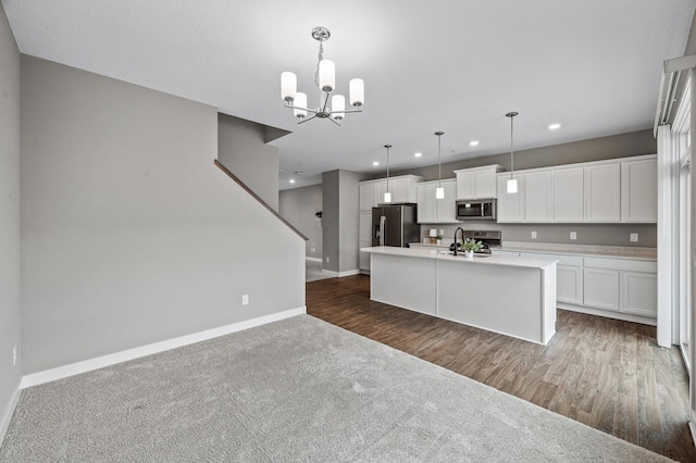 5040 93rd Ln N, Brooklyn Park, MN 55443 - kitchen featuring appliances with stainless steel finishes, baseboards, a sink, recessed lighting, and an island with sink