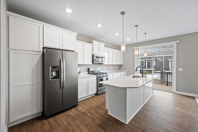 5040 93rd Ln N, Brooklyn Park, MN 55443 - kitchen featuring stainless steel appliances, a sink, white cabinetry, a center island with sink, and recessed lighting