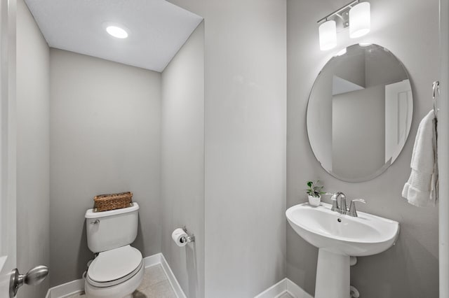5040 93rd Ln N, Brooklyn Park, MN 55443 - half bath featuring toilet, baseboards, and tile patterned floors