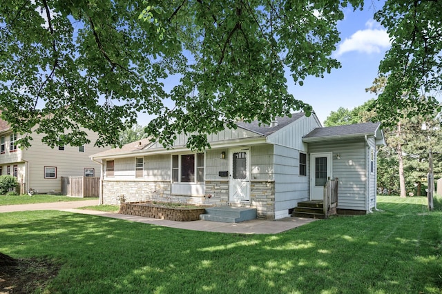 5030 Jefferson St NE, Columbia Heights, MN 55421 - view of front of property featuring a front yard, stone siding, and a shingled roof