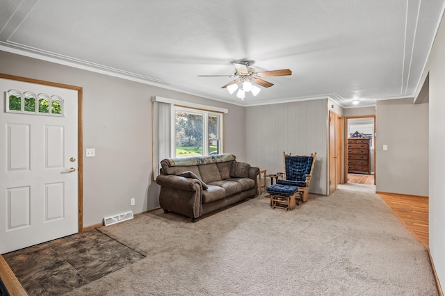 5030 Jefferson St NE, Columbia Heights, MN 55421 - carpeted living area featuring healthy amount of natural light, crown molding, ceiling fan, and baseboards