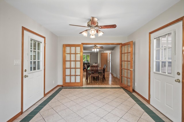 5030 Jefferson St NE, Columbia Heights, MN 55421 - foyer featuring inlaid floor details, french doors, light tile patterned floors, and baseboards