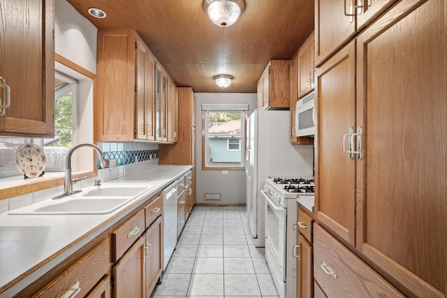 5030 Jefferson St NE, Columbia Heights, MN 55421 - kitchen featuring white appliances, a sink, glass insert cabinets, and light countertops