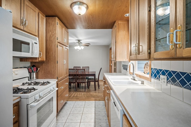 5030 Jefferson St NE, Columbia Heights, MN 55421 - kitchen featuring white appliances, a sink, a ceiling fan, light tile patterned flooring, and light countertops