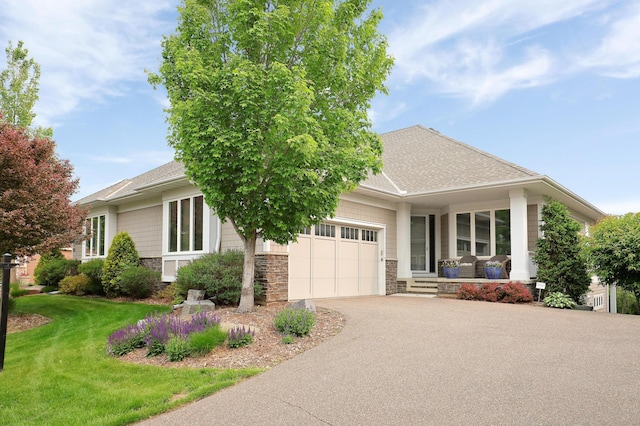 2524 Sandstone Ln, Orono, MN 55356 - view of front of property featuring stone siding, a porch, asphalt driveway, a garage, and a front yard