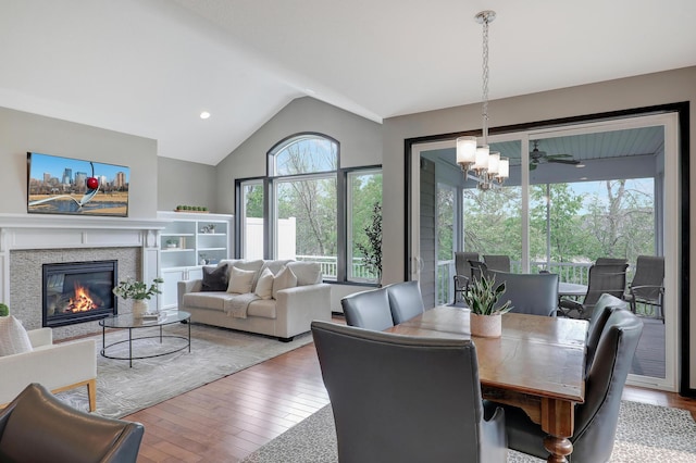2524 Sandstone Ln, Orono, MN 55356 - dining area with vaulted ceiling, hardwood / wood-style flooring, a glass covered fireplace, and recessed lighting