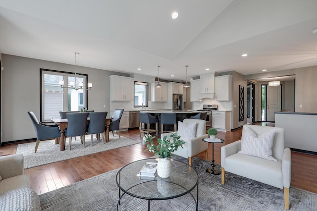 2524 Sandstone Ln, Orono, MN 55356 - living room with vaulted ceiling, wood finished floors, recessed lighting, and a chandelier