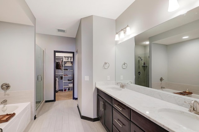 2524 Sandstone Ln, Orono, MN 55356 - full bath featuring a shower stall, a bath, double vanity, and a walk in closet