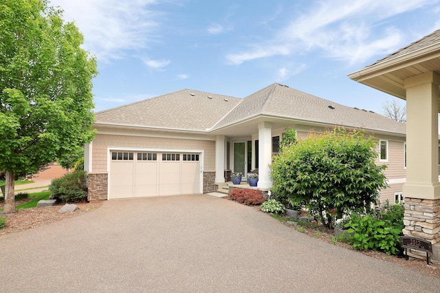 2524 Sandstone Ln, Orono, MN 55356 - view of front of home with stone siding, asphalt driveway, an attached garage, and a shingled roof