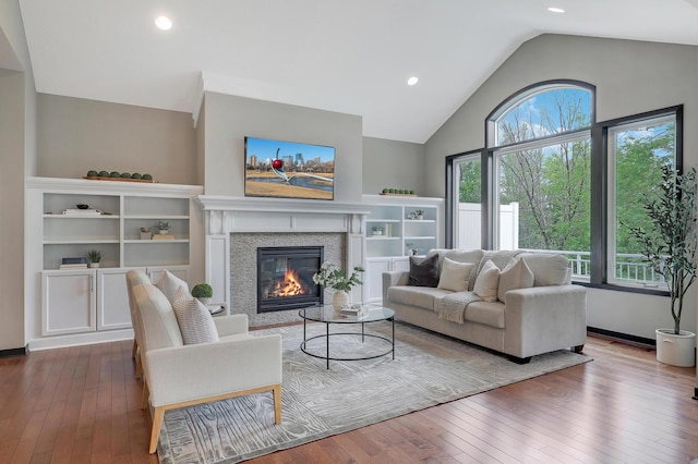 2524 Sandstone Ln, Orono, MN 55356 - living room with vaulted ceiling, wood-type flooring, a glass covered fireplace, and recessed lighting