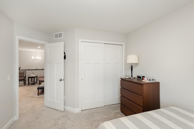 1212 Lower 143rd St E, Rosemount, MN 55068 - bedroom with light carpet, baseboards, a closet, and a chandelier