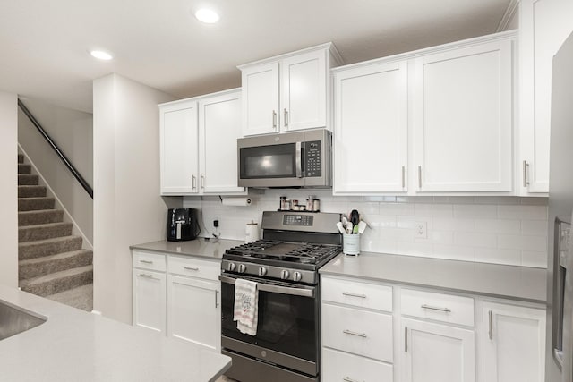 1212 Lower 143rd St E, Rosemount, MN 55068 - kitchen with stainless steel appliances, backsplash, white cabinets, recessed lighting, and light countertops