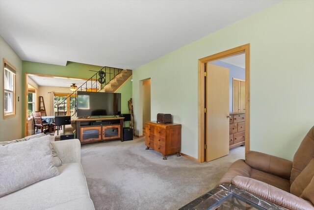 16957 Lake Netta Dr NE, Ham Lake, MN 55304 - living area with carpet flooring, ceiling fan, and stairway