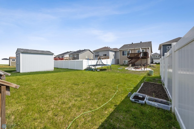 1546 68th Ave S, Fargo, ND 58104 - view of yard featuring a trampoline, a residential view, a deck, a garden, and stairs