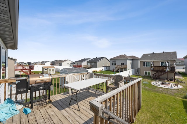 1546 68th Ave S, Fargo, ND 58104 - wooden deck featuring a residential view, an outdoor fire pit, stairway, and a yard