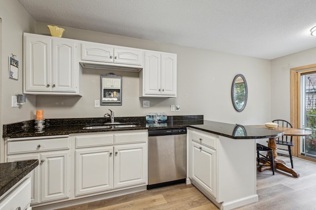 1198 Saint Clair Ave, Saint Paul, MN 55105 - kitchen with dishwasher, a sink, light wood finished floors, a peninsula, and white cabinets