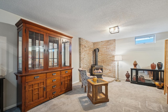 1198 Saint Clair Ave, Saint Paul, MN 55105 - carpeted living room featuring a wood stove, a textured ceiling, and baseboards