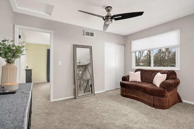 7674 Dunmore Rd, Woodbury, MN 55125 - carpeted living room featuring a ceiling fan, attic access, and baseboards
