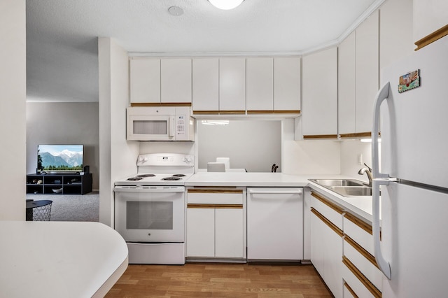 7510 Cahill Rd Unit 211B, Edina, MN 55439 - kitchen with white appliances, white cabinets, light countertops, and light wood-style floors