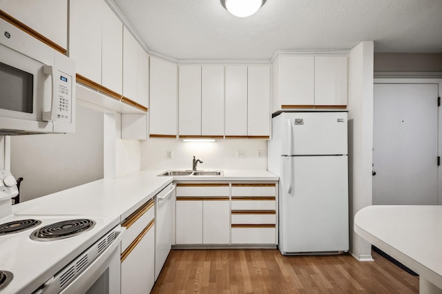 7510 Cahill Rd Unit 211B, Edina, MN 55439 - kitchen featuring white appliances, light wood finished floors, light countertops, white cabinets, and a textured ceiling