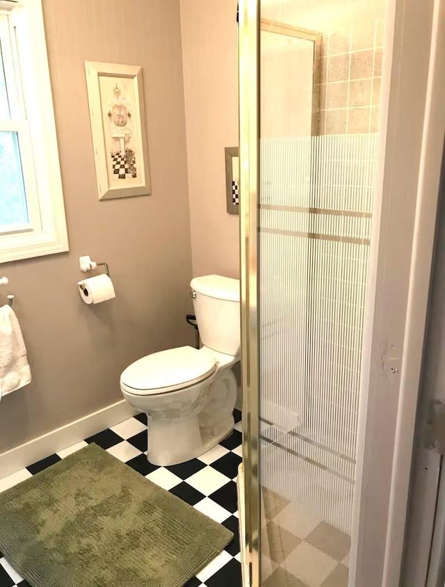 13394 77th St NW, Annandale, MN 55302 - full bathroom with tile patterned floors, toilet, a shower stall, and baseboards