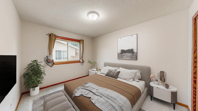 2209 18th Ave SE, Rochester, MN 55904 - bedroom featuring light colored carpet, baseboards, and a textured ceiling