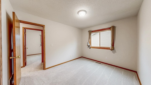2209 18th Ave SE, Rochester, MN 55904 - unfurnished room with light carpet, baseboards, and a textured ceiling