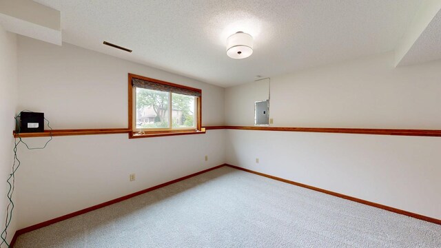 2209 18th Ave SE, Rochester, MN 55904 - carpeted spare room with electric panel, a textured ceiling, and baseboards