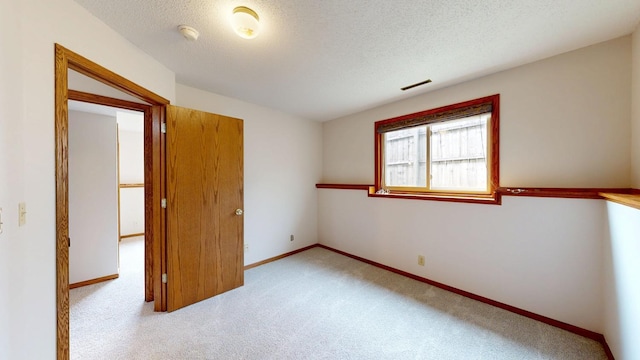 2209 18th Ave SE, Rochester, MN 55904 - unfurnished bedroom with carpet flooring, baseboards, and a textured ceiling