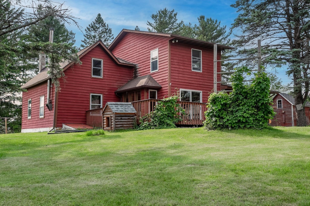 N8355 330th St, Gilman Twp, WI 54767 - rear view of house with a deck, a lawn, and a chimney