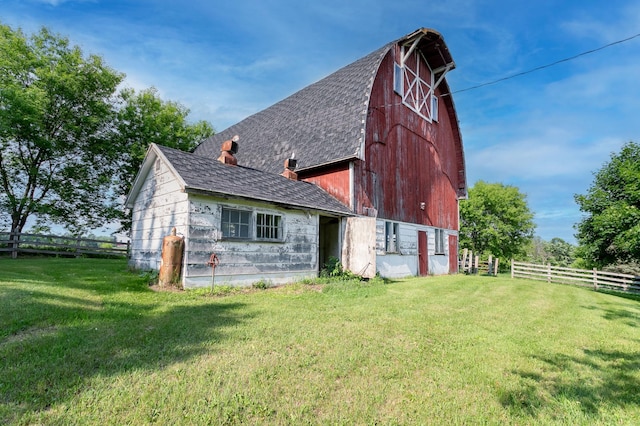 N8355 330th St, Gilman Twp, WI 54767 - back of house featuring a barn, an outbuilding, roof with shingles, and a chimney