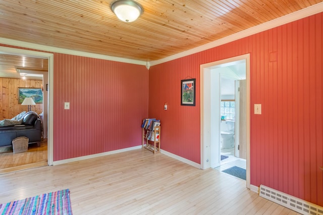 N8355 330th St, Gilman Twp, WI 54767 - spare room with crown molding, light wood-type flooring, wood walls, and wooden ceiling