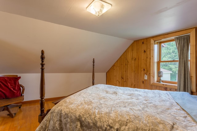 N8355 330th St, Gilman Twp, WI 54767 - bedroom featuring wood finished floors, lofted ceiling, and wood walls
