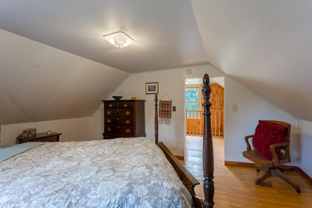 N8355 330th St, Gilman Twp, WI 54767 - bedroom with light wood-type flooring and vaulted ceiling