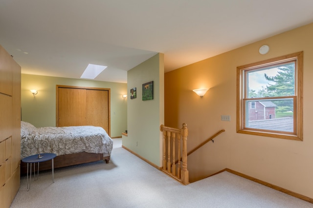 N8355 330th St, Gilman Twp, WI 54767 - bedroom with a skylight, light carpet, baseboards, and a closet