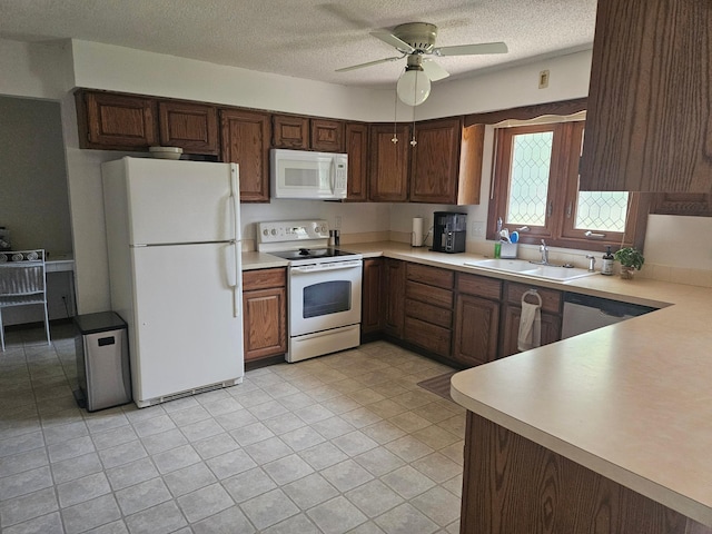 1427 Canary Dr, Albert Lea, MN 56007 - kitchen featuring white appliances, a sink, a ceiling fan, light countertops, and a textured ceiling